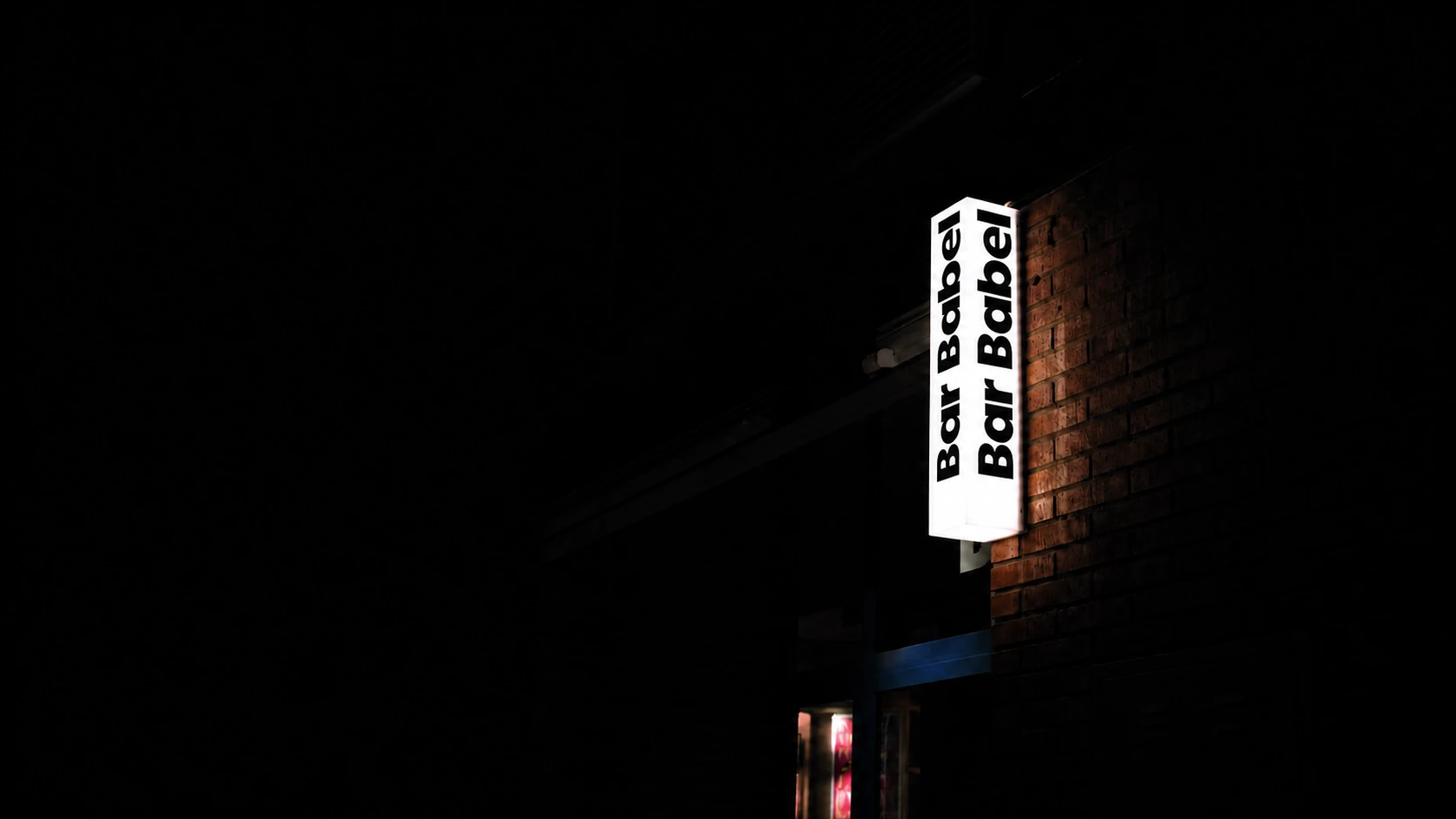 La caixa de llum de Bar Babel encesa de nit